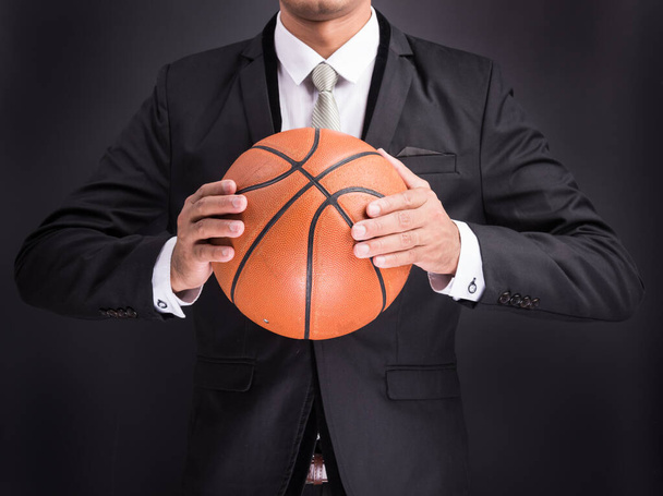 Young businessman holding basketball ball - Photo, Image