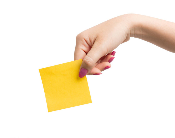 Woman hand holding blank yellow notepaper - Foto, afbeelding