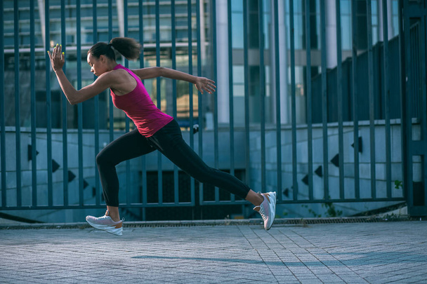 Professional sportswoman in the street running quickly alone. Template banner - Foto, immagini