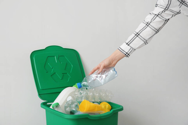 Woman throwing garbage into container. Recycling concept - Φωτογραφία, εικόνα