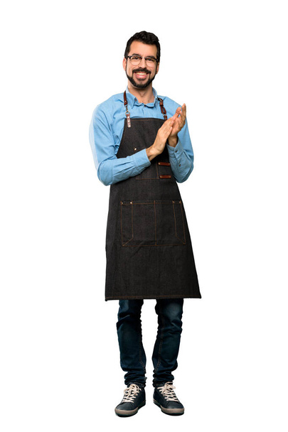 Full-length shot of Man with apron applauding after presentation in a conference over isolated white background - Photo, Image
