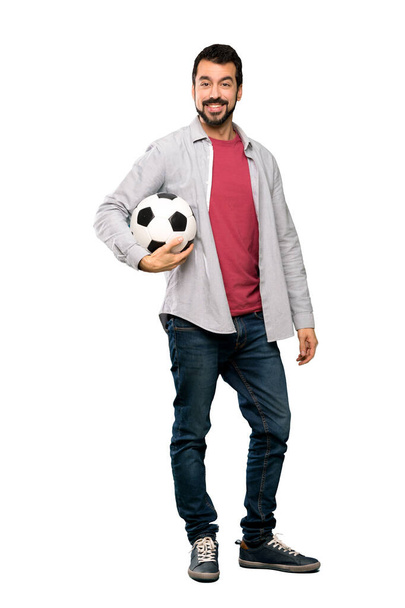Full-length shot of Handsome man with beard holding a soccer ball over isolated white background - Foto, Imagem
