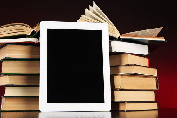 Tablet and books on bright background - Foto, afbeelding