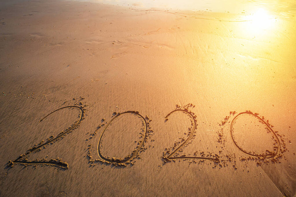 Happy New Year 2020 text on beautiful the sea beach with wave ea - Фото, зображення