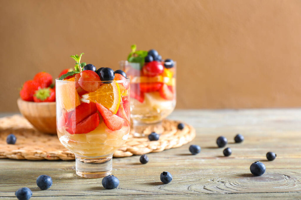 Glasses with tasty fruit salad on table - Φωτογραφία, εικόνα