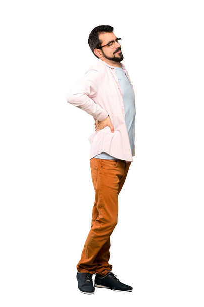Full-length shot of Handsome man with beard suffering from backache for having made an effort over isolated white background - Foto, Imagem