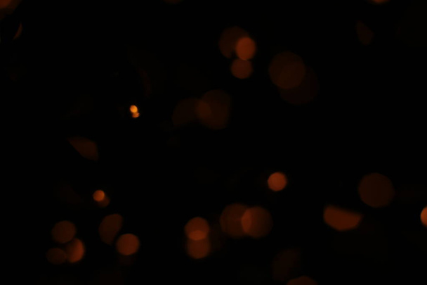 Defocused lights of warm shade, festive background. Christmas garland out of focus. - Photo, Image