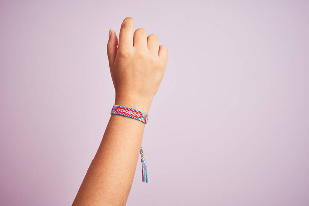 Model arm with beautiful handmade colorful bracelet on wrist - Фото, изображение