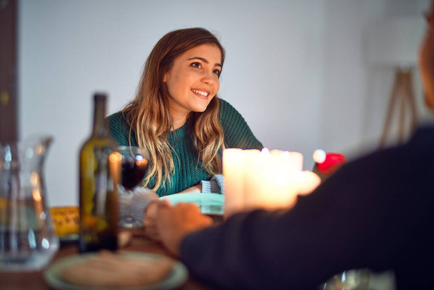 Young beautiful couple smiling happy and confident. on romantic meeting at home - 写真・画像