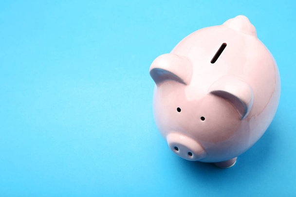 Pink piggy bank on blue background - Foto, immagini