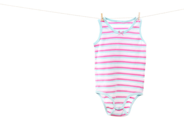 Baby clothes hanging on white background - 写真・画像
