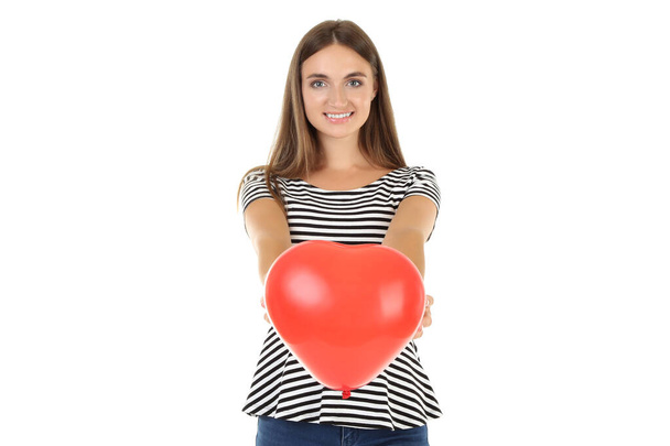 Young woman holding balloon in shape of heart on white backgroun - Фото, изображение