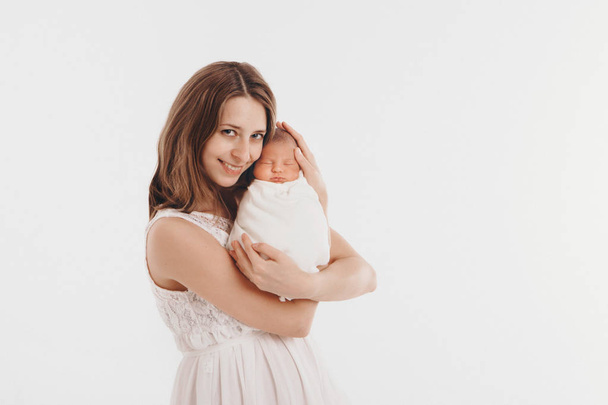 the concept of a healthy lifestyle, the protection of children, shopping - baby in the arms of the mother. Woman holding a child - Фото, изображение