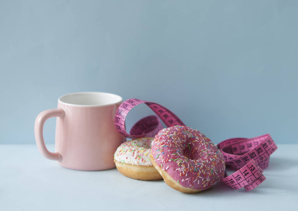 Delicious doughnuts with sprinkles on color background - Photo, Image