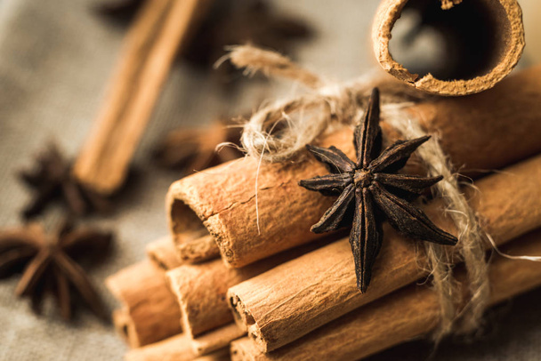 cinnamon sticks and star anise on wooden background - Photo, image