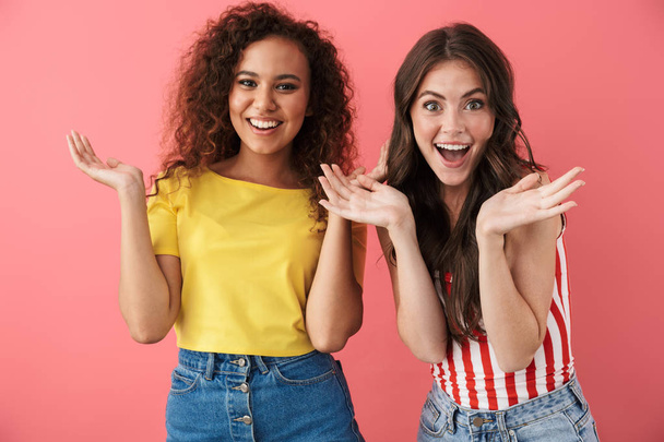 Image of delighted multinational girls wondering and raising hands in surprise - Photo, Image