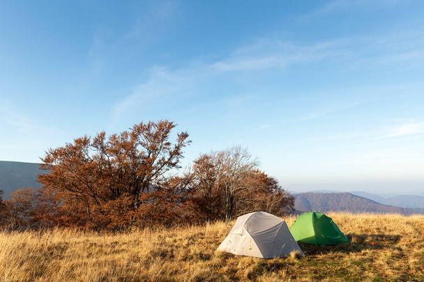 Two tents on amazing meadow in autumn mountains - Photo, Image