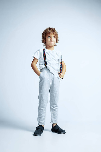 Pretty young boy in casual clothes on white studio background - Fotoğraf, Görsel