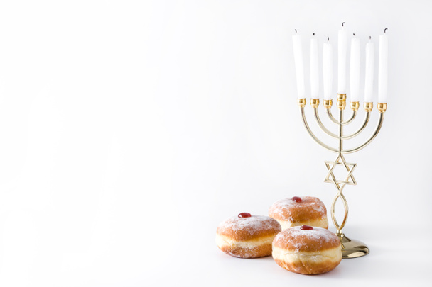 Jewish Hanukkah menorah and sufganiyot donuts isolated on white background. Copy space - Photo, Image
