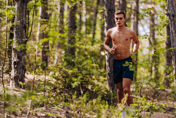 Sprinting running man. Male  runner training outdoors jogging on mountain path - Foto, Imagen