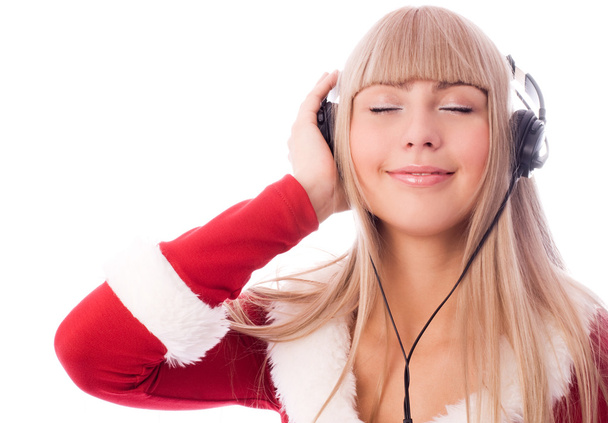 Girl dressed as Santa listening to the music - Foto, Imagem