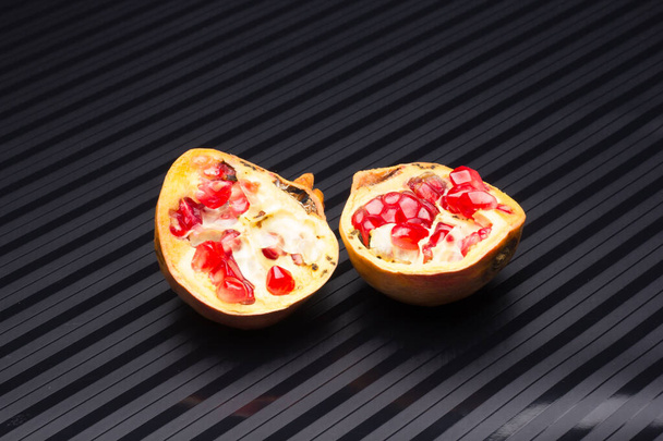 Open pomegranate, full of red, sweet, crispy and tasty beans - Photo, Image