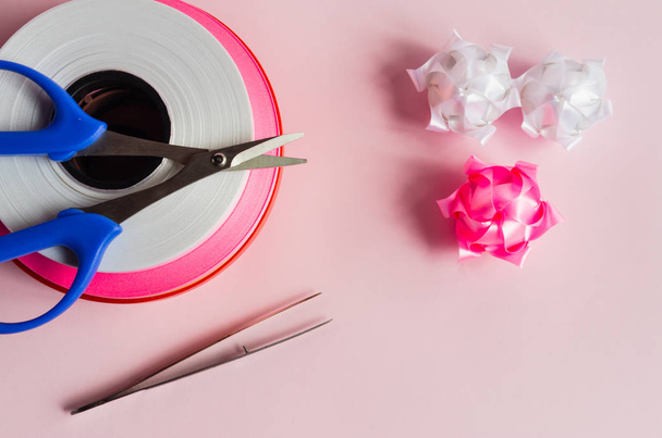Стрічковий рулон на рожевому фоні з ножицями і
 - Фото, зображення