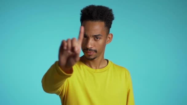 Denying, Rejecting, Disagree, Portrait of handsome guy. African american man disapproving with no hand sign make negation finger gesture. Slow motion. - Кадри, відео