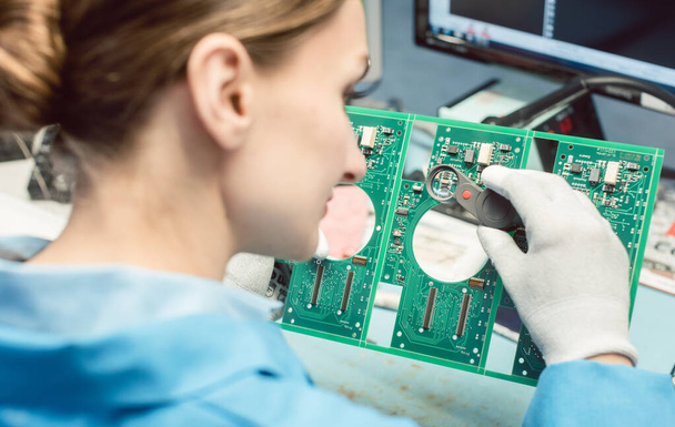 Technician soldering components to a PCB - Фото, изображение