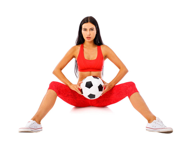 Fitness woman in a red sports suit with soccer balls  - Photo, Image
