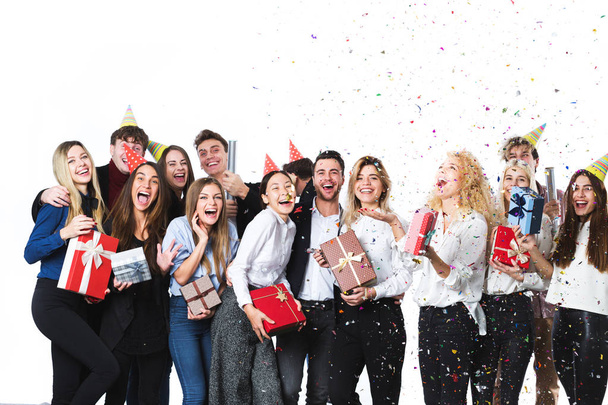 Beautiful people having fun on a white background. Concept celebrating New Year or Christmas. - Foto, immagini