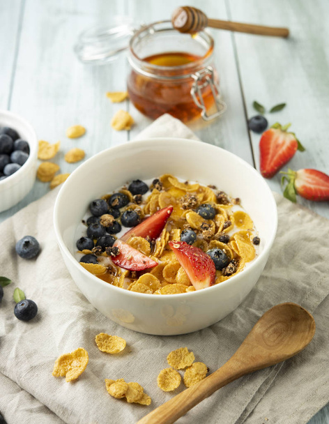 breakfast with cornflakes and berries on wooden background  top view - Fotografie, Obrázek
