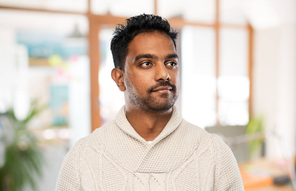 indian man in sweater over office background - Foto, Imagen