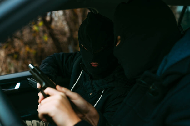 bank robbers putting their mask on prepared to do their next rob - Φωτογραφία, εικόνα