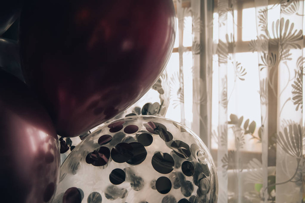 a few pink and purple silver ballons closeup decorations present   - 写真・画像