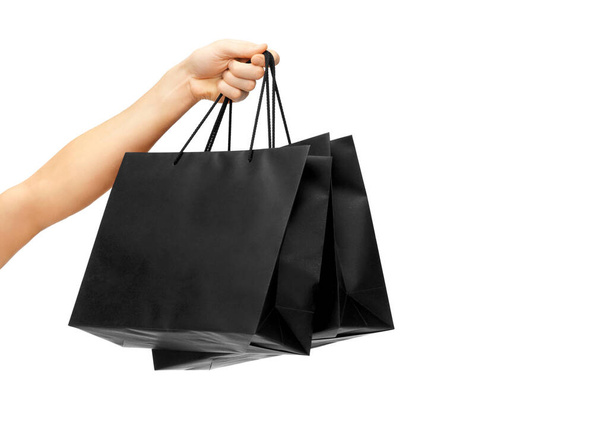 female hand holding black shopping bags - Photo, image