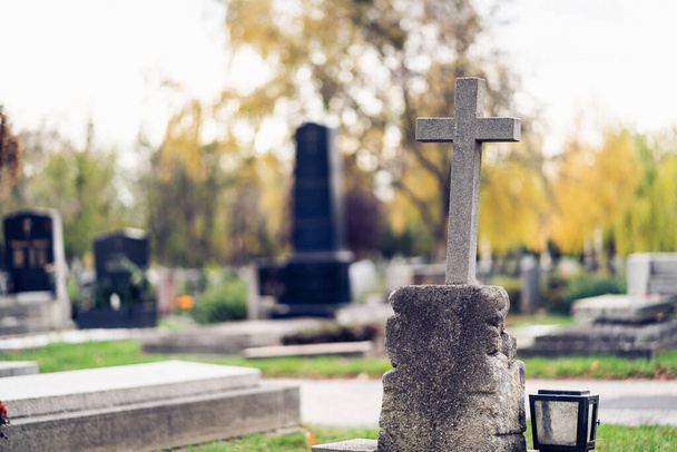 Graves at a cemetery. Cross in the foreground. - Foto, Bild
