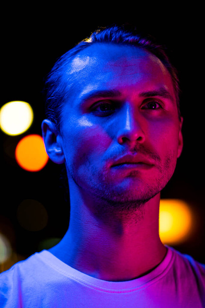 Modern red and blue light portrait of a young man - Photo, Image