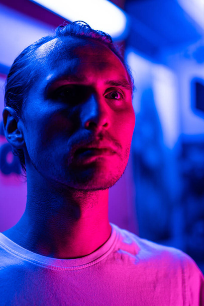 Modern red and blue light portrait of a young man - Fotografie, Obrázek