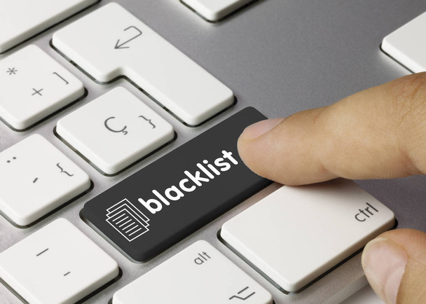 blacklist - Inscription on Black Keyboard Key. blacklist Written on Black Key of Metallic Keyboard. Finger pressing key - Photo, Image