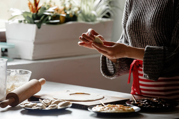 woman cooking  polish dumplings at kitchen - Foto, Bild