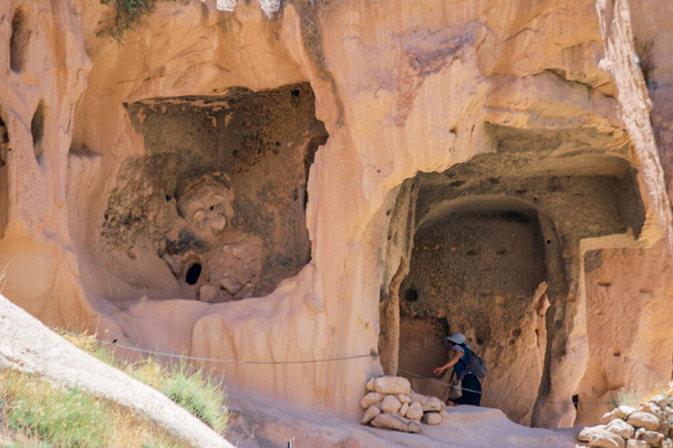 Ancient volcanic stones with caves and holes, Cappadocia, Turkey. - Fotoğraf, Görsel