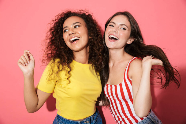 Two cheerful young girls wearing summer clothing - Fotó, kép