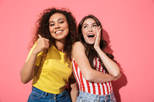Two cheerful young girls wearing summer clothing - Valokuva, kuva