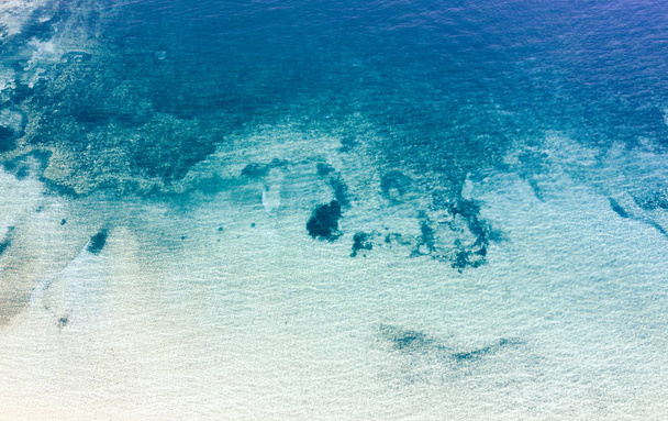 Rocks in blue sea water - Фото, изображение