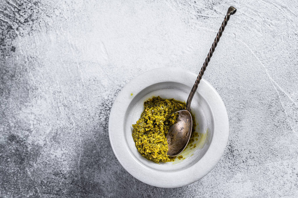 Italian Pesto in marble mortar. Space for text. Gray background - Fotó, kép