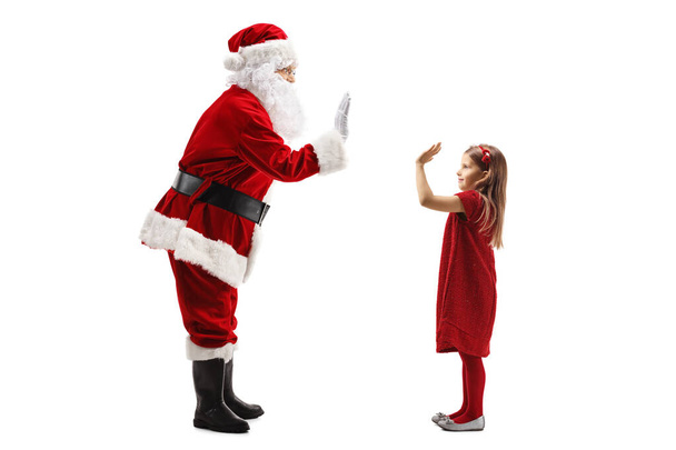 Joulupukki elehtii yläfemma pikkutytön kanssa
 - Valokuva, kuva