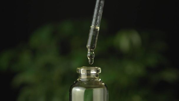 Extreme close up of the glass jar bottle with medical cannabis c - Fotoğraf, Görsel