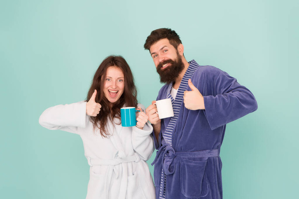 perfect weekend. good morning. morning couple drink coffee. bearded man and girl coffee cup. they feel rested. family life routine. couple in love. love relationship. warm up our relations. tea time - Фото, зображення