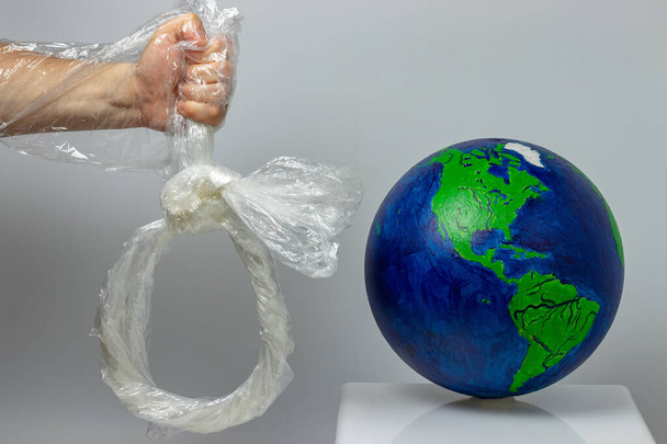 Man can destroy the environment of planet earth with plastic bags - Foto, immagini